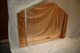 An Art Deco style wall mirror, peach in colour with etched decoration of a leaping deer,