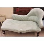 A Victorian walnut framed chaise longue with candy stipe upholstery on scrolling legs