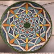A pottery charger decorated with geometric patterns, marked Liguori Raito Vieti,
