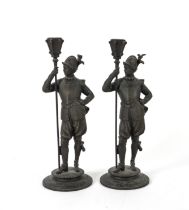 TWO FRENCH SPELTER FIGURAL CANDLESTICKS MODELLED AS GUARDS (2)