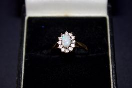 9ct Gold ring set with opal & white stones Weight