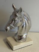 Chrome horses head on marble base
