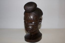 Single carved African hardwood bust of a woman with incised facial scarification and coiffed hair