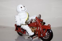 Cast iron Michelin man on motorbike