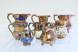 Set of 8 English copper lustre miniature jugs