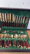Boxed brass and rosewood handled flatware set