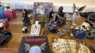 Group of fantasy and occult-themed figurines and books