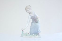 Lladró porcelain figure of a girl picking flowers
