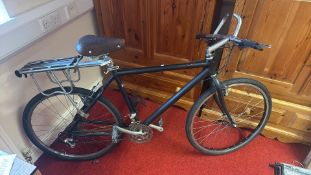 One Selle Royal saddle-fitted road bicycle with flat handlebars, alloy wheels, derailleur gears, and