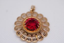 18ct Gold pendant set with red gem stone Weight