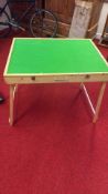 A portable jigsaw puzzle table with green felt work surface, softwood frame, folding trestle legs