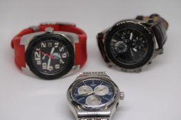 Three wristwatches to include a swatch and a puma
