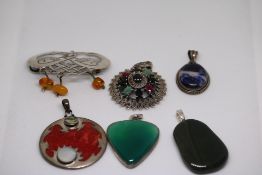 Collection of white metal pendants set with hardst