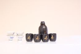 Set of Asian ceramic sake bottle and cups