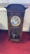 Oak-cased wall clock with pendulum and weights