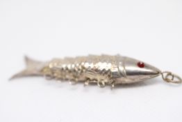 White metal articulating fish pendant