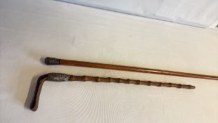 Pair of walking canes with carved and metal-mounted handles
