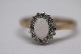 9ct Gold ring set with central opal surrounded by