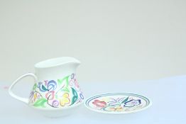 2 pieces of Poole, England, earthenware comprising a milk jug and a matching saucer, each