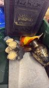 Group of decorative items including Game of Thrones book and glassware