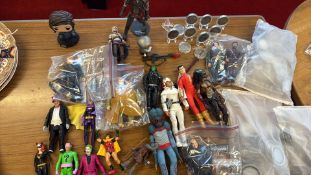 Group of assorted action figures with accessories and commemorative-style coins