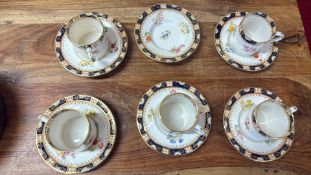 Group of porcelain floral teacups and saucers with gilt and cobalt borders
