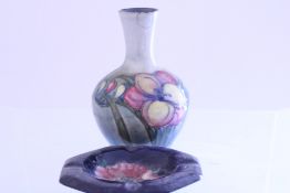 2 Moorcroft pottery pieces comprising a tube-lined vase with stylised floral decoration on a
