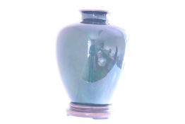 A blue-green iridescent glass vase, ovoid with short waisted neck, mounted with a copper rim and