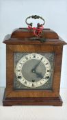 A walnut eight-day mantel clock with brass handle and chime movement (working and chiming well)