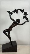 Patinated bronze dancer with vine garland on marble base