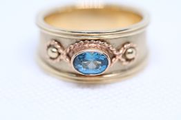 9ct Gold ring set with raised blue topaz Total wei