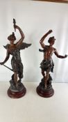 A pair of patinated spelter figural sculptures after classical models on wooden plinths (tallest