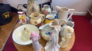 A group of assorted ceramic jugs, bowls and figurines