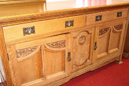 Arts and Crafts oak sideboard, the moulded top above a long frieze drawer with hammered copper