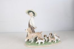 Lladro Privilege porcelain figure group, modelled as a young boy in straw hat and overalls with a