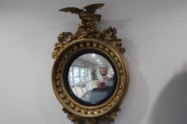 19th century regency gilded convex mirror featurin
