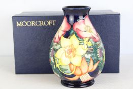 Moorcroft pottery baluster vase, made in Stoke-on-Trent, England, in a tubelined polychrome floral