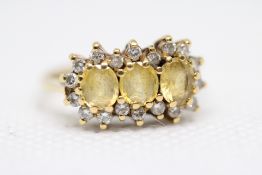 18ct Gold ring set with 3 Citrine surrounded by di