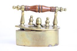 A miniature brass flat iron, turned wooden handle