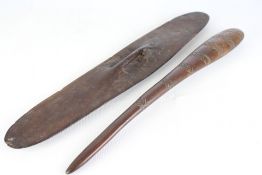 Carved hardwood sheild and fighting club, the sheild of elongated leaf form with integral grip;