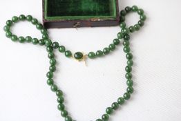 A beautiful, long jade necklace believed to be ear
