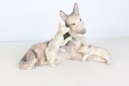 Lladro glazed porcelain figural group of a reclining dog with two puppies, in grey and cream tones