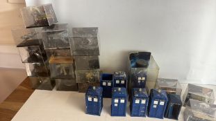A group of Doctor Who TARDIS and sciâ€‘fi model miniatures in display cases
