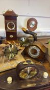 A group of decorative wooden mantel and wall clocks