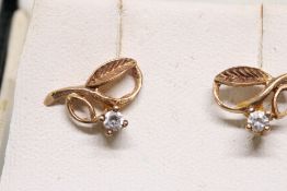 Yellow metal earrings set with small diamonds