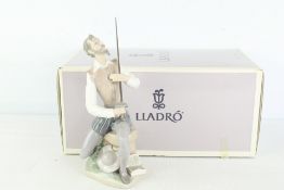 Lladró glazed porcelain figure of a seated gentleman with sword, boxed