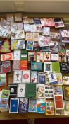 A group of assorted playing card decks and novelty card games