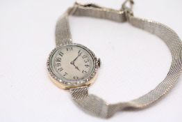 Ladies 18ct Gold cased mechanical watch on 9ct gol