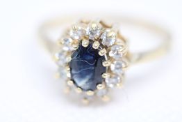 Yellow Gold cluster ring set with central sapphire