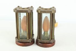 A pair of industrial brass and glass caged table lamps